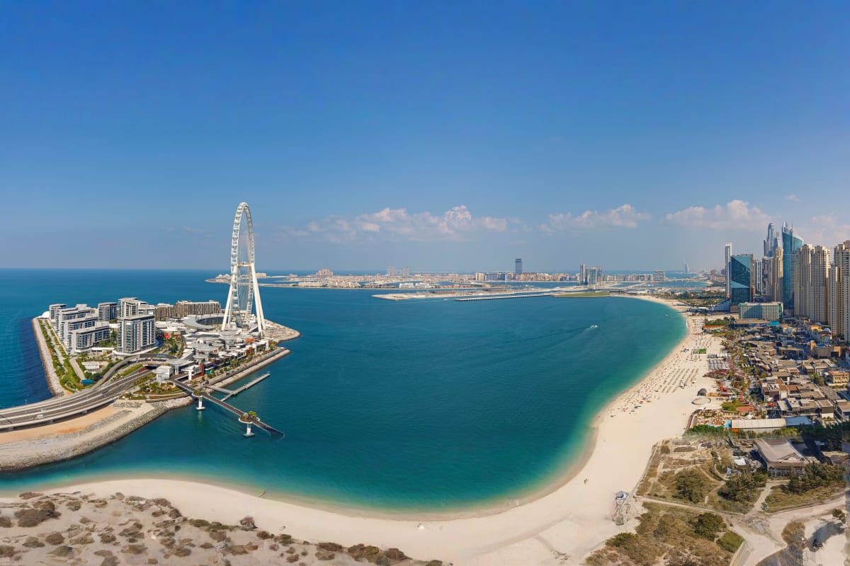 Ain Dubai observation wheel with white central pillar and cable supports overlooking Dubai coastline and turquoise water (3)