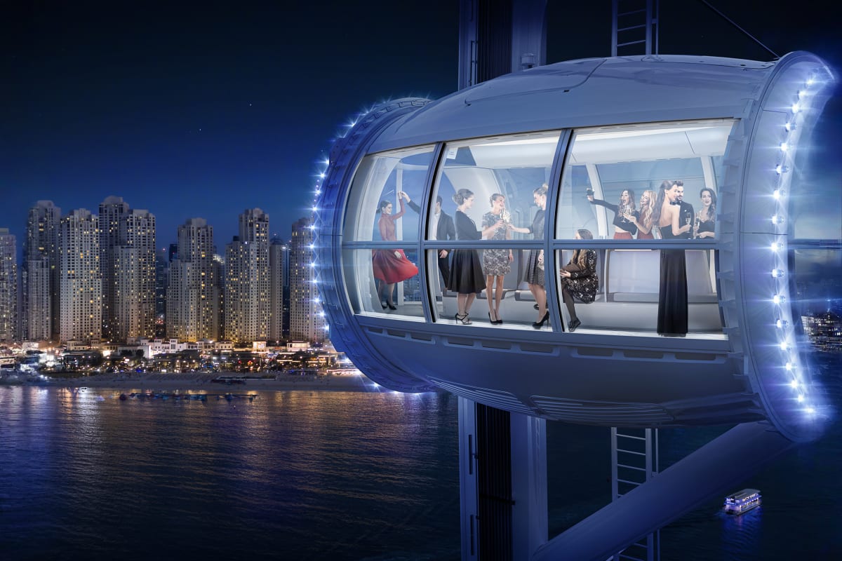 Ain Dubai observation wheel with white central pillar and cable supports overlooking Dubai coastline and turquoise water (5)