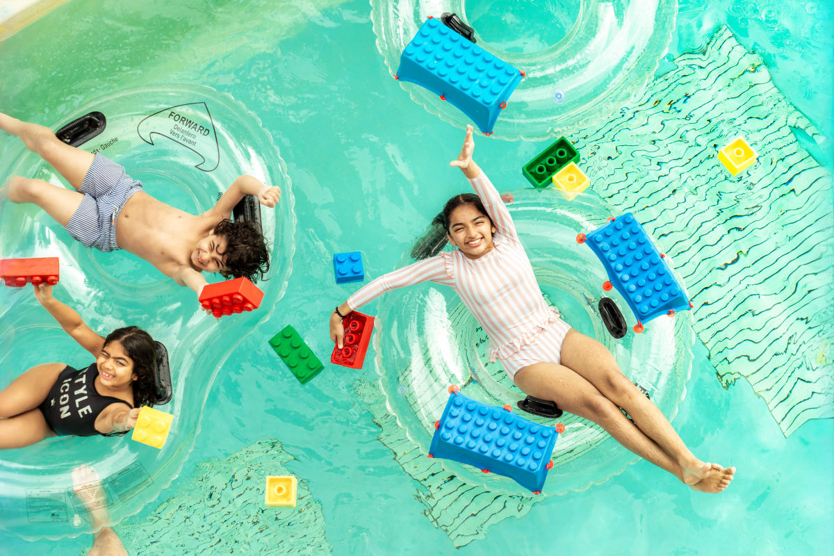 Family enjoying LEGOLAND Dubai entrance area with colorful brick castle structure and themed attractions (2)