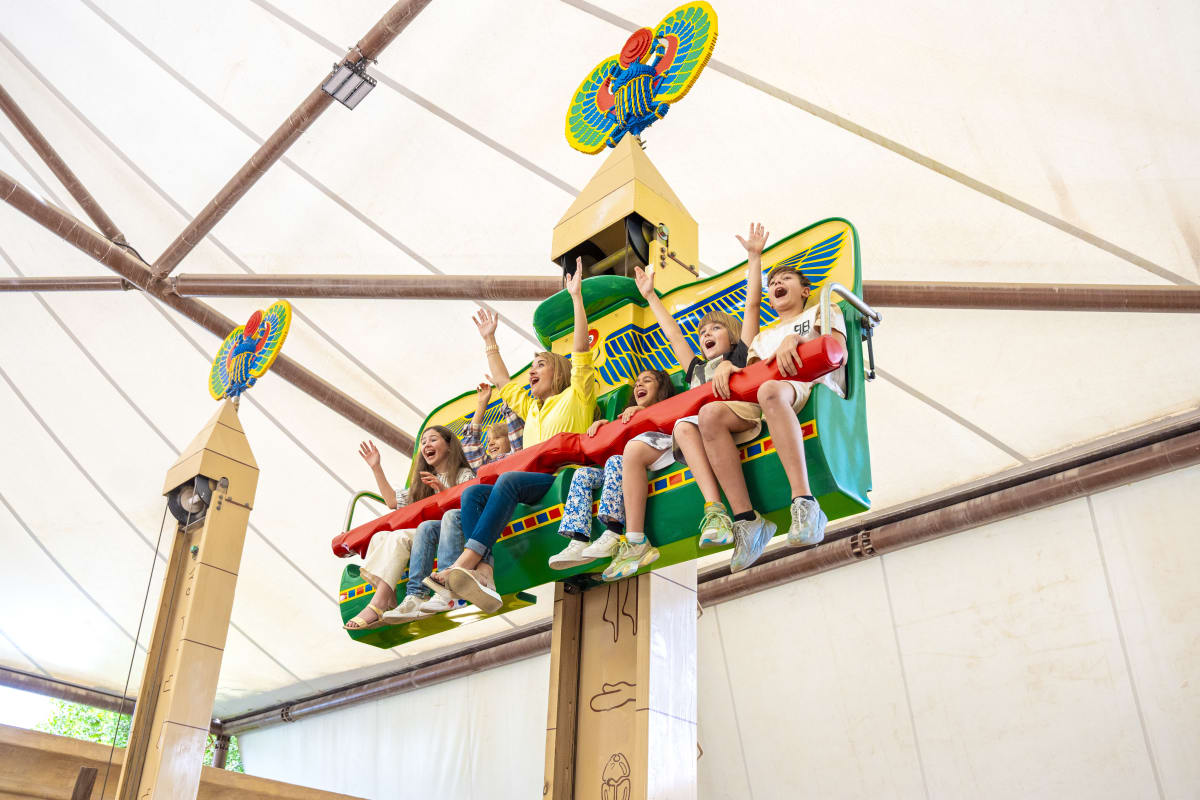 Family enjoying LEGOLAND Dubai entrance area with colorful brick castle structure and themed attractions (4)